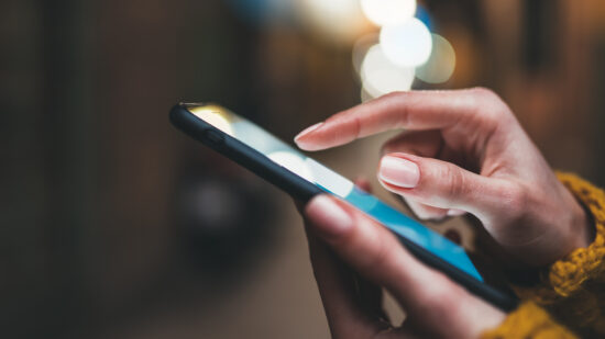 point finger on screen phone closeup, person texting text messag